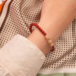 Hand wearing red agate and white chalcedony bracelet – simple gemstone jewelry for everyday wear