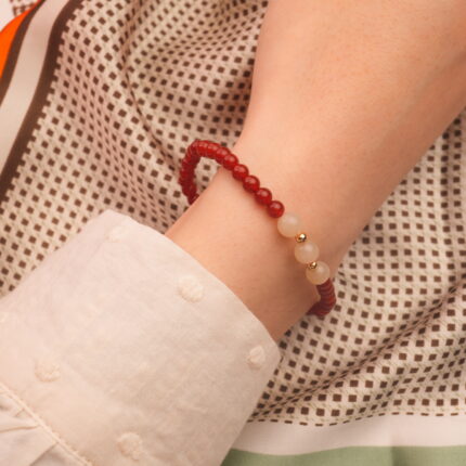 Hand wearing red agate and white chalcedony bracelet – simple gemstone jewelry for everyday wear