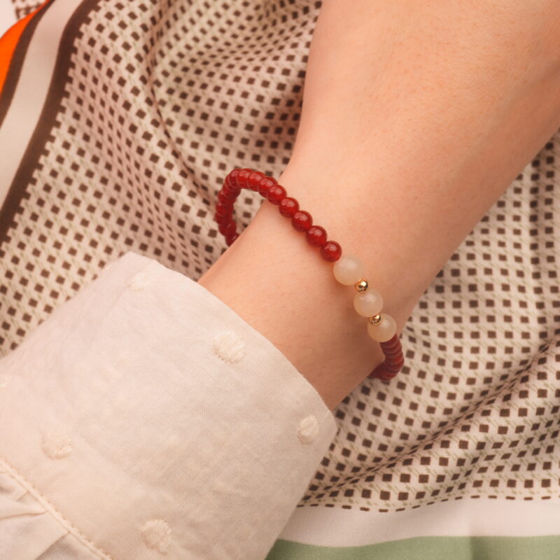 Hand wearing red agate and white chalcedony bracelet – simple gemstone jewelry for everyday wear