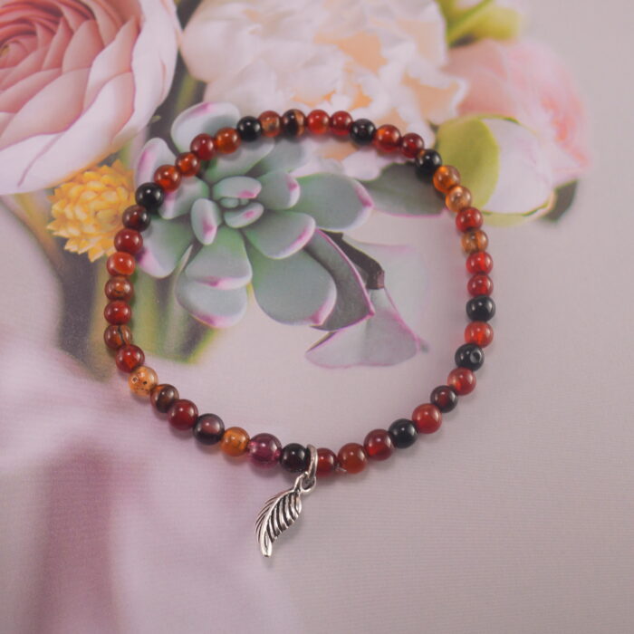 Agate charm bracelet styled with natural props for vitality and grounding