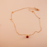 Handmade red jasper pendant necklace displayed on neutral background