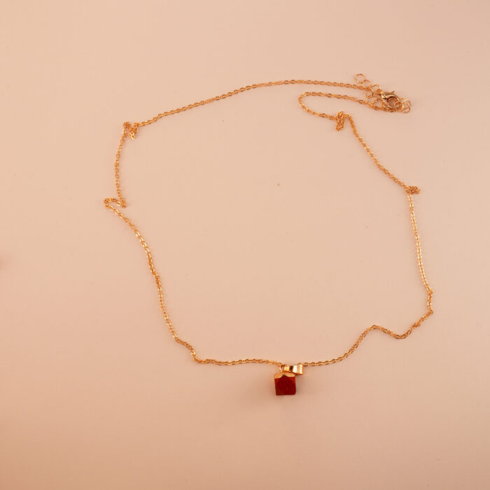 Handmade red jasper pendant necklace displayed on neutral background