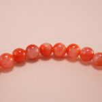 Close-up view of 4mm red and white chalcedony beads