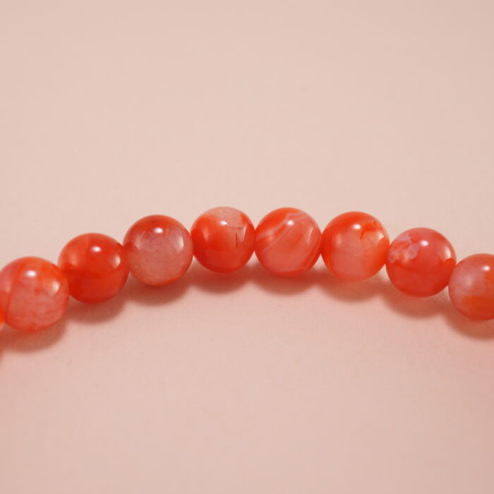 Close-up view of 4mm red and white chalcedony beads