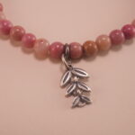 Close-up of Rhodochrosite Beads and Leaf Charm – Crystal Healing Bracelet for Love and Calm