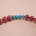 Close-up of Rhodochrosite, Turquoise Beads and Flower Charm – Elegant Gemstone Charm Bracelet