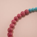 Close-up of Rhodochrosite, Turquoise Beads and Flower Charm – Elegant Gemstone Charm Bracelet