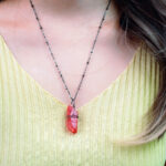 Model wearing pendant, showcasing rich color and texture