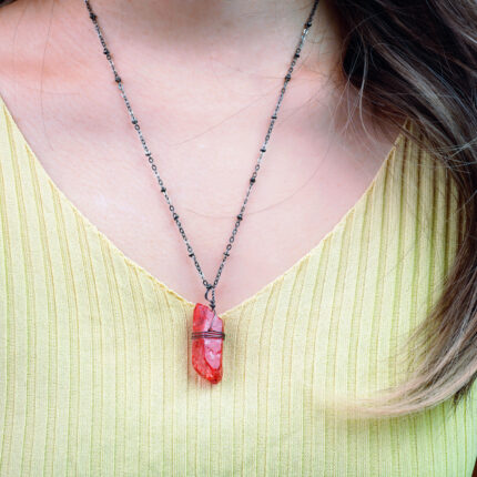 Model wearing pendant, showcasing rich color and texture