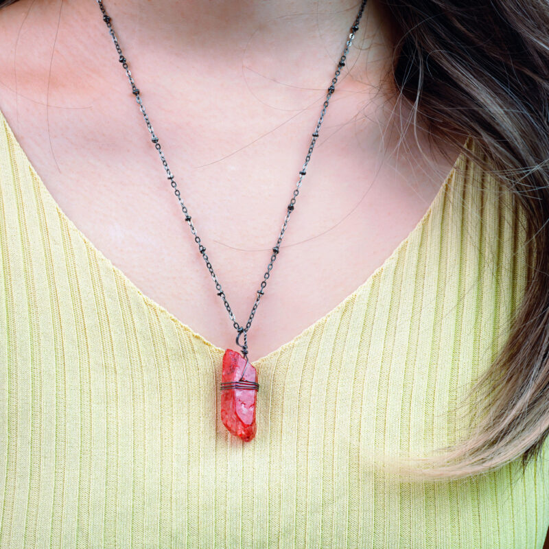 Model wearing pendant, showcasing rich color and texture