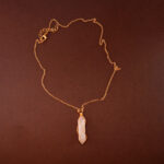 Handmade rose quartz point pendant necklace on a soft or white background