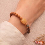 Wearing handmade beaded bracelet with sandalwood and Alashan stone