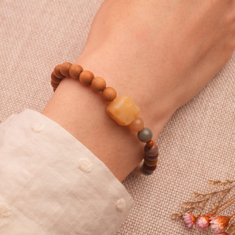 Wearing handmade beaded bracelet with sandalwood and Alashan stone