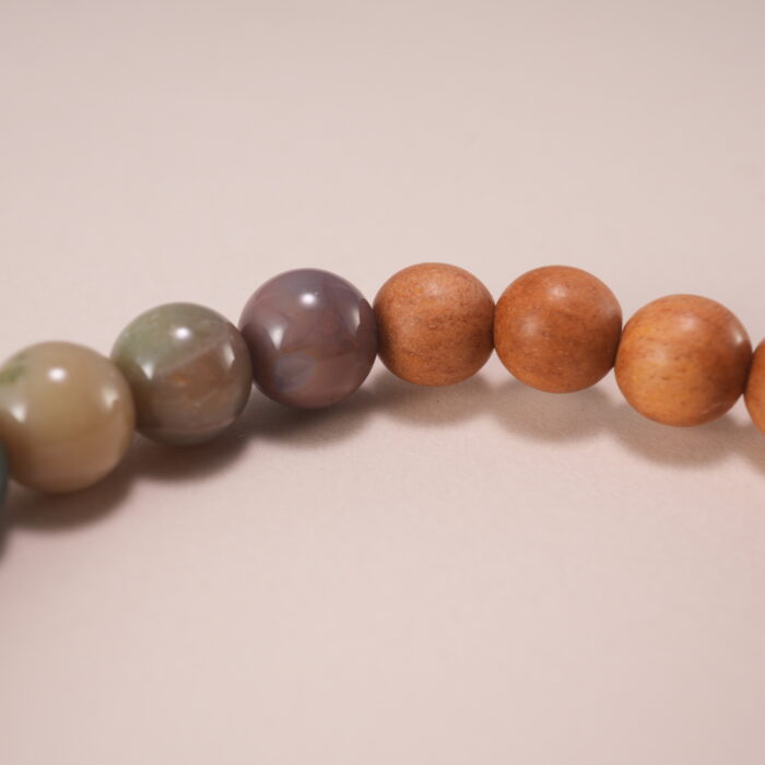 Wearing handmade beaded bracelet with sandalwood and Alashan stone