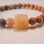 Wearing handmade beaded bracelet with sandalwood and Alashan stone