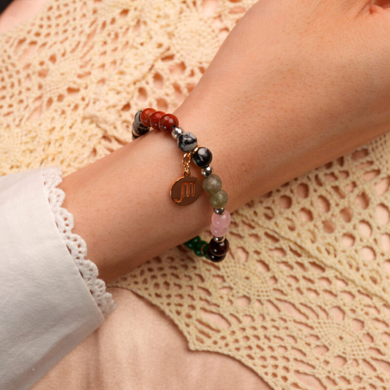Model wearing Scorpio bracelet highlighting malachite and rose quartz beads