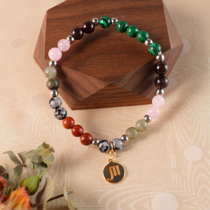 Scorpio bracelet displayed on rustic wooden surface highlighting natural stones
