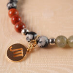 Close-up detail of Scorpio bracelet beads made of malachite and obsidian