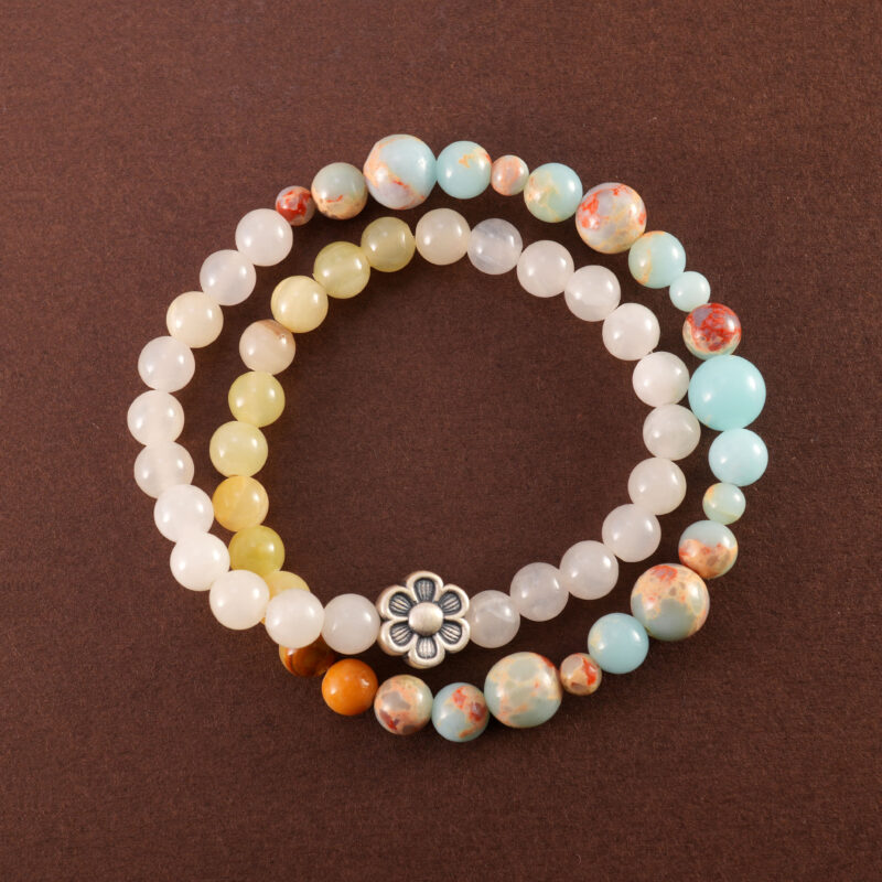 Colorful chalcedony bracelet with flower charm, displayed on white background