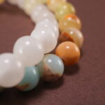 Close-up of gemstone textures and floral charm on chalcedony bracelet