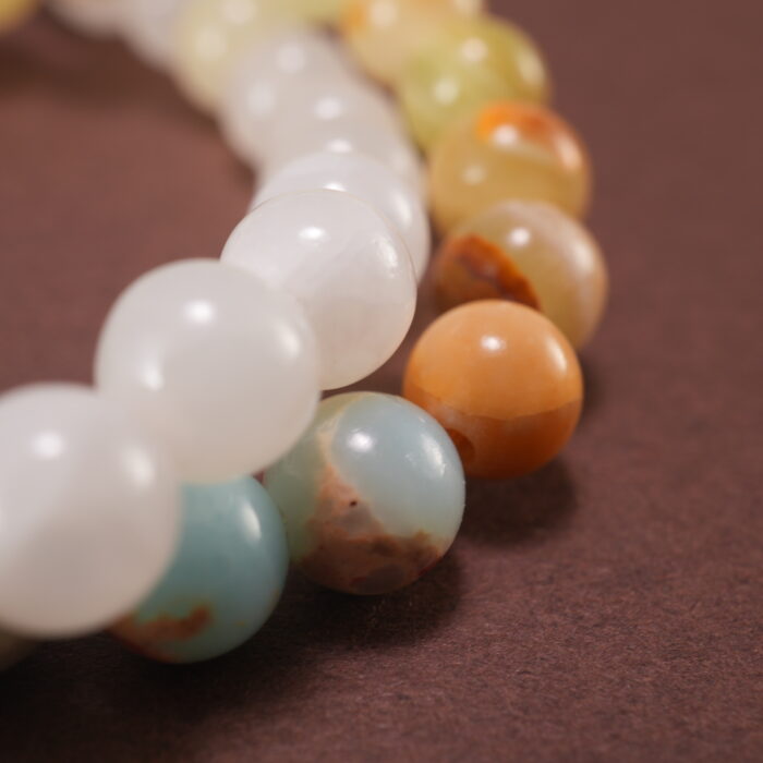 Close-up of gemstone textures and floral charm on chalcedony bracelet