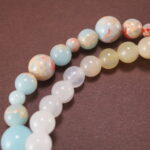 Close-up of gemstone textures and floral charm on chalcedony bracelet
