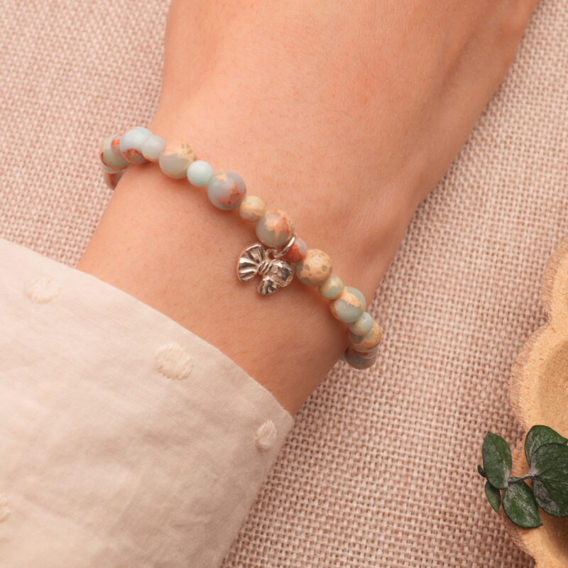 Wrist shot showing the Shoushan stone bracelet worn with a neutral-toned outfit