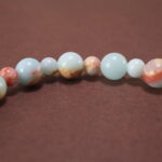 Close-up of polished Shoushan stone beads and string detail