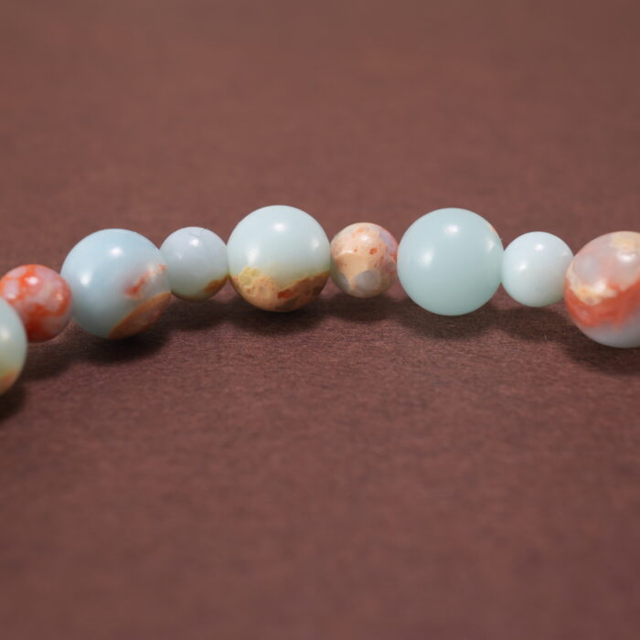 Close-up of polished Shoushan stone beads and string detail