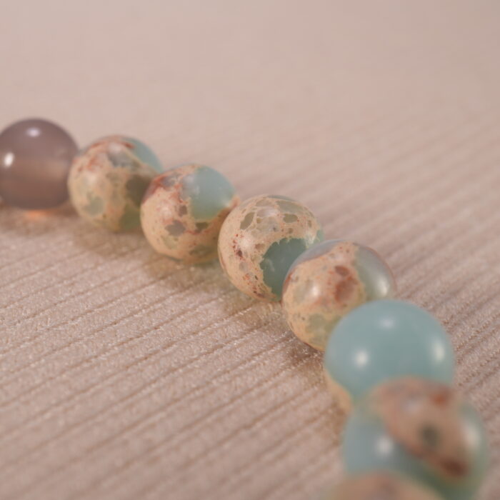 Close-up of gray agate and Shoushan beads with polished finish