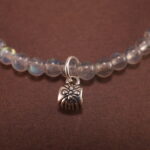 Close-up of soft blue chalcedony beads with carved flower accents