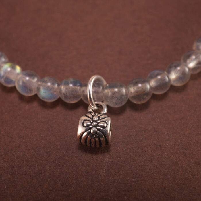 Close-up of soft blue chalcedony beads with carved flower accents