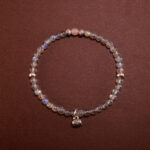 Handmade Chalcedony bracelet with floral and leaf charms, designed to promote restful sleep
