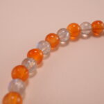 Close-up of natural chalcedony and moonstone beads with detailed S925 fish charm