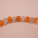Close-up of natural chalcedony and moonstone beads with detailed S925 fish charm