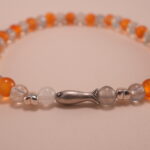 Close-up of natural chalcedony and moonstone beads with detailed S925 fish charm