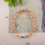Chalcedony and Moonstone bracelet placed beside a peaceful setting