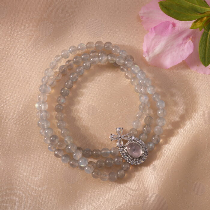 Gray Moonstone Bracelet resting in a tranquil natural setting under soft light