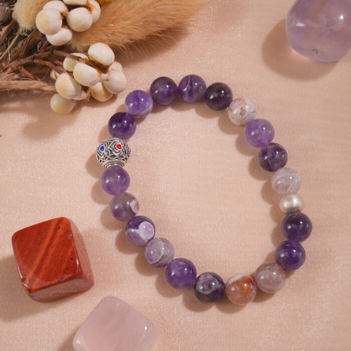 Amethyst bracelet placed in a peaceful, nature-inspired setting