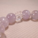 Close-up of transparent quartz beads and soft purple amethyst