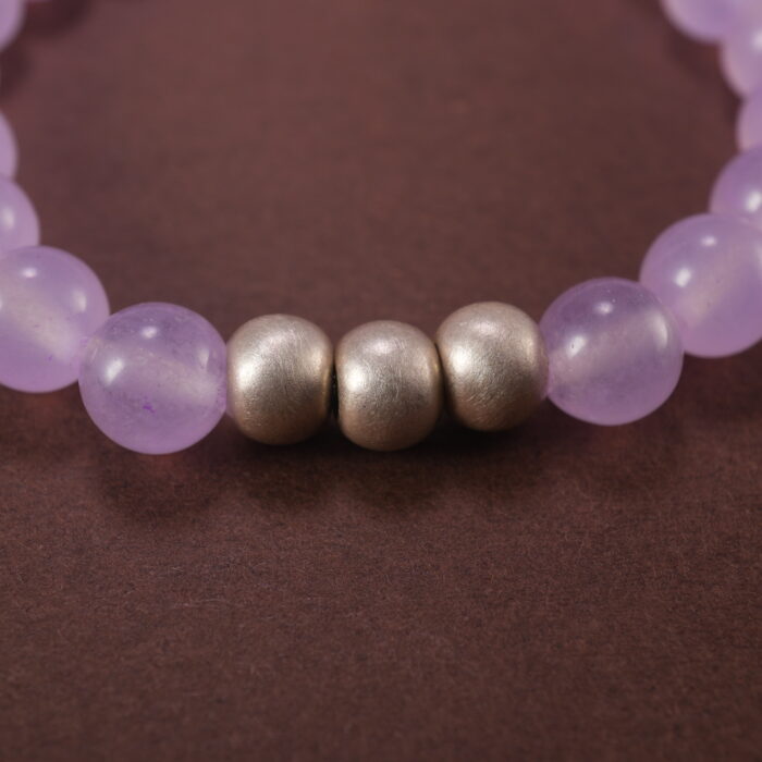 Close-up of polished lavender amethyst and moon charm detailing