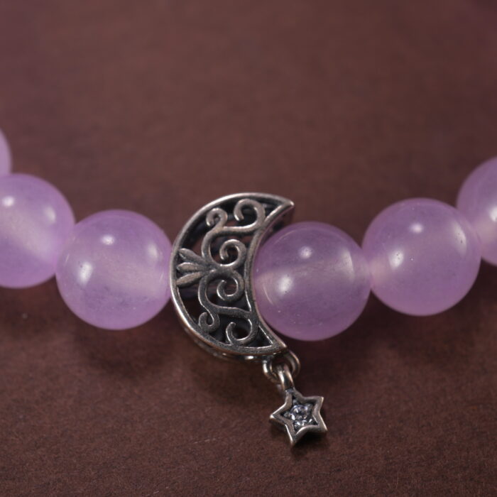 Close-up of polished lavender amethyst and moon charm detailing