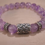 Zoomed-in shot showing the natural clarity and soft purple hue of each amethyst bead