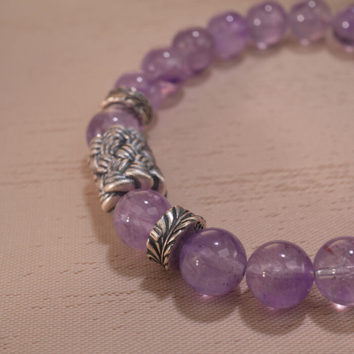 Zoomed-in shot showing the natural clarity and soft purple hue of each amethyst bead