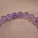Zoomed-in shot showing the natural clarity and soft purple hue of each amethyst bead