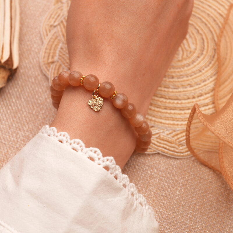 Worn on the wrist of a model with soft lighting, suggesting love, care, and serenity