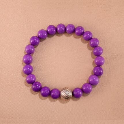 Phosphosiderite bracelet made of round purple 8mm beads, neatly arranged on a light background