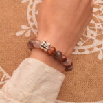 Bracelet worn alone on the wrist, highlighting its gentle purple hues and smooth crystal finish