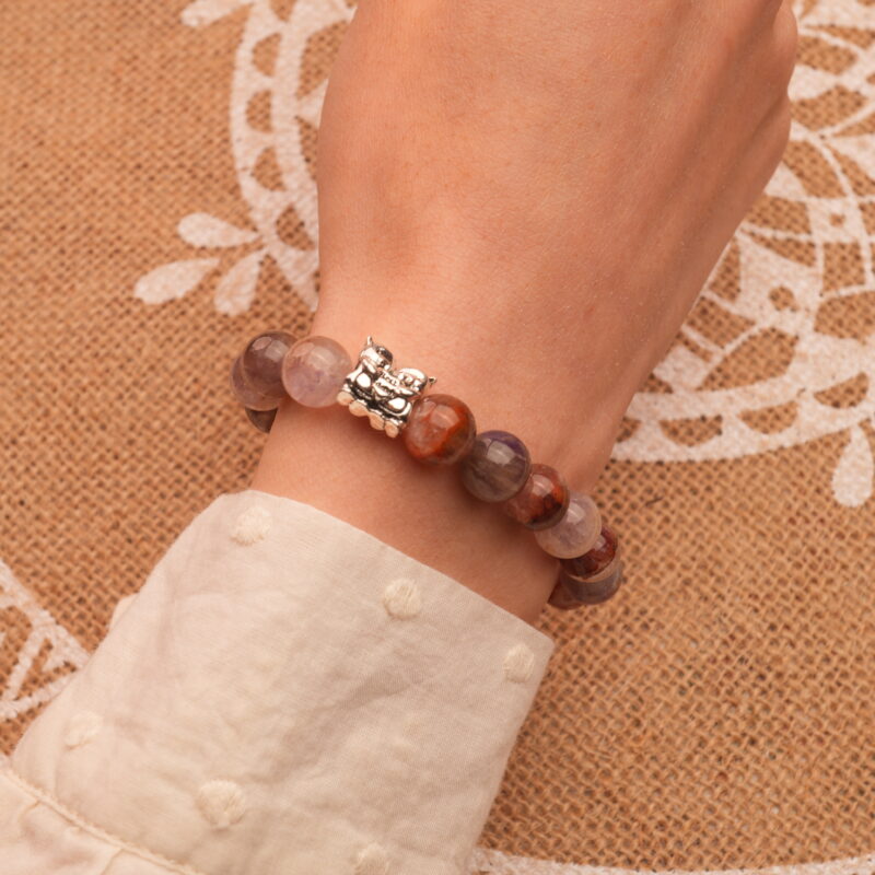 Bracelet worn alone on the wrist, highlighting its gentle purple hues and smooth crystal finish