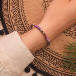 Model wearing the bracelet casually, emphasizing its subtle size and restful energy
